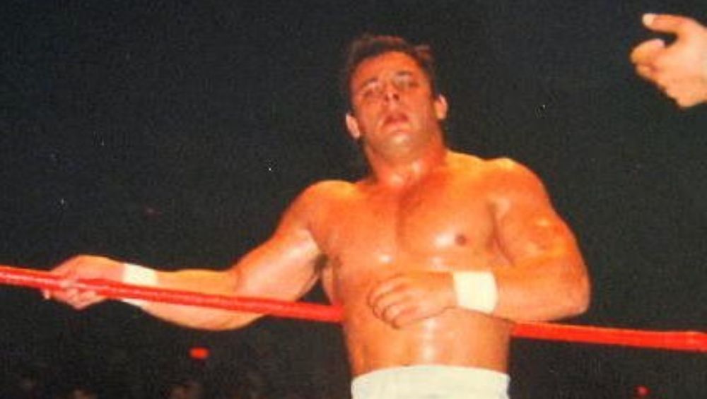 Dynamite Kid leaning against a ring rope