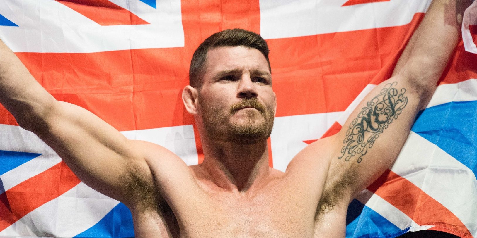 michael-bisping-with-the-british-flag-raised-over-his-head