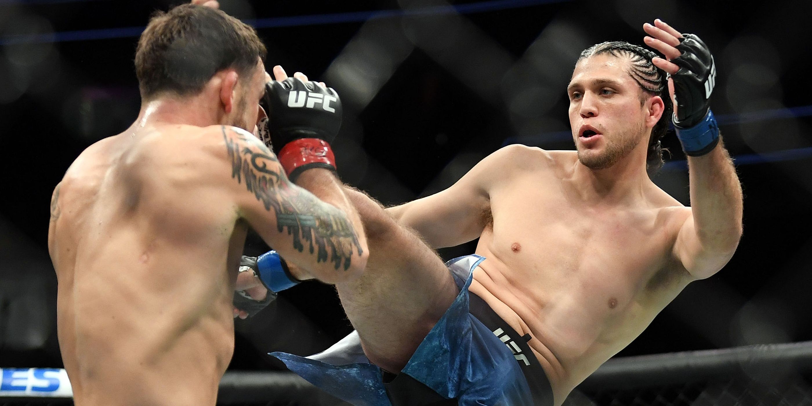 Brian Ortega throws a kick in the UFC cage