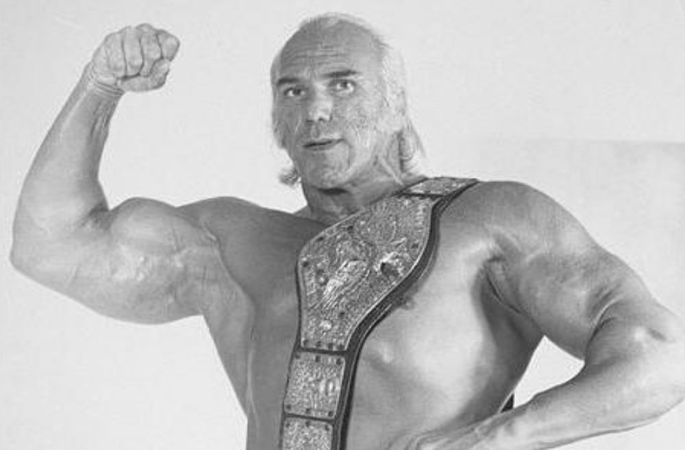 Superstar Billy Graham flexing with the WWE Championship