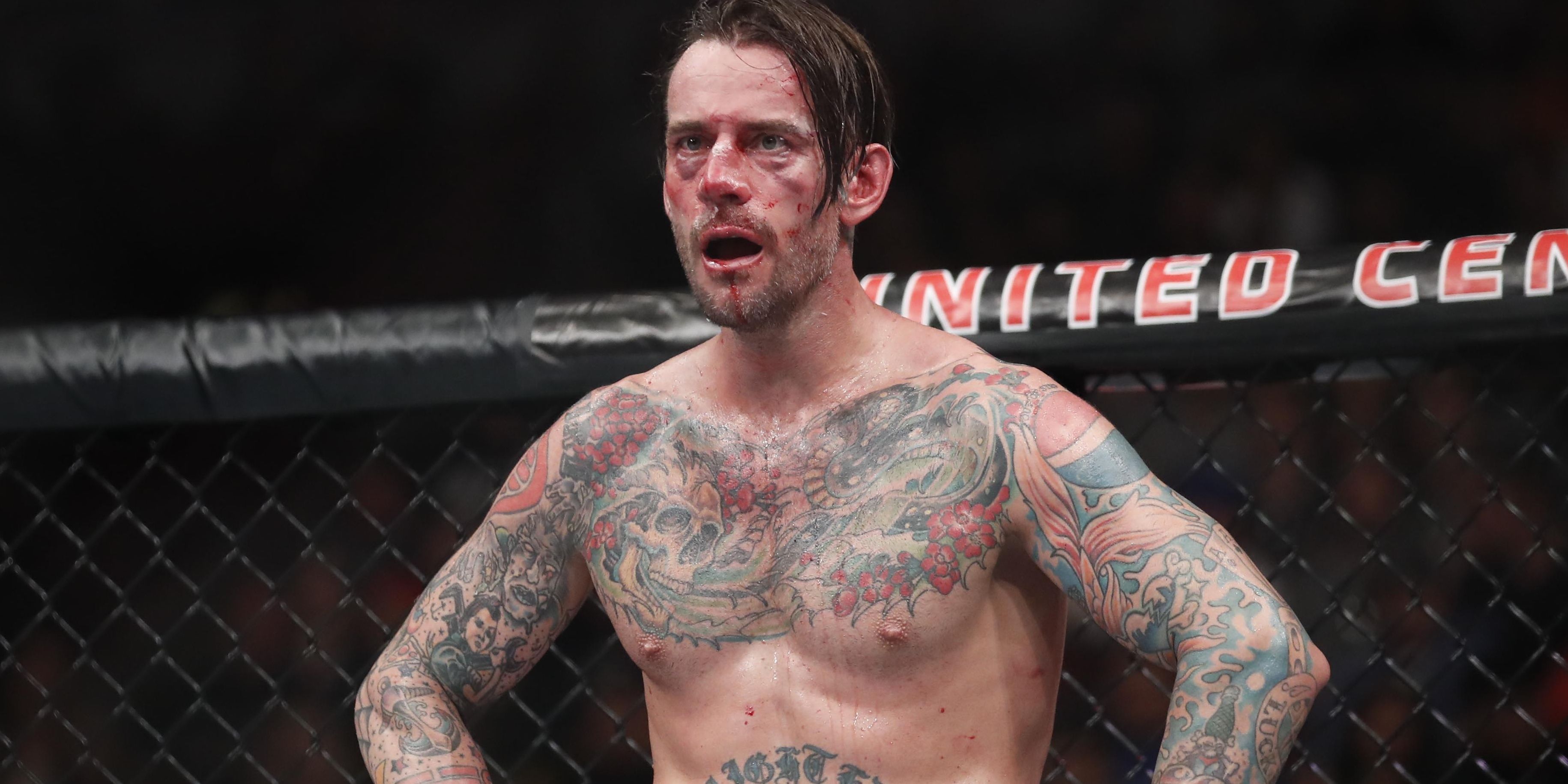 cm-punk-bloodied-and-battered-with-his-hands-on-his-hips