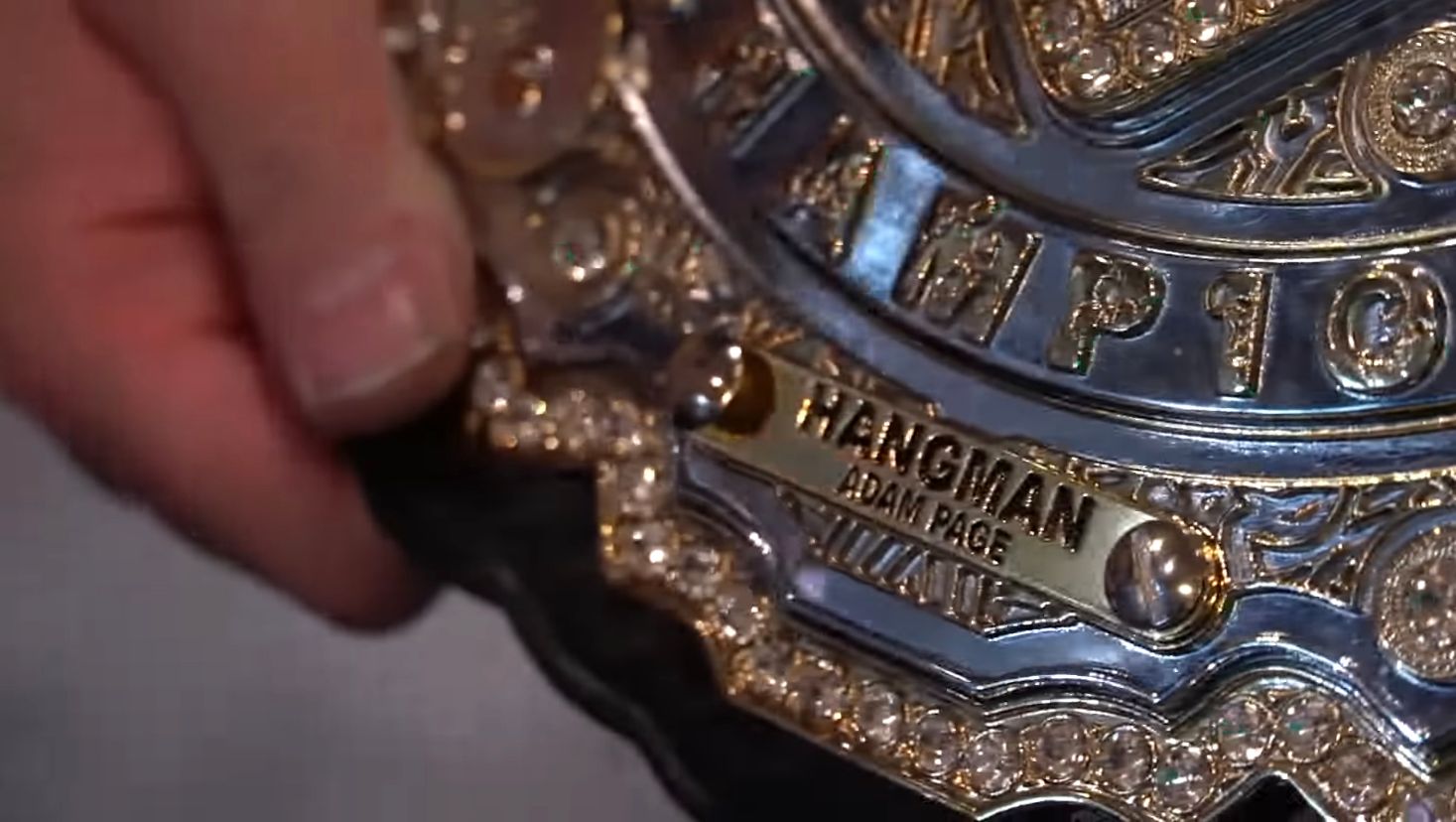 Hangman Page's name plate on the AEW championship