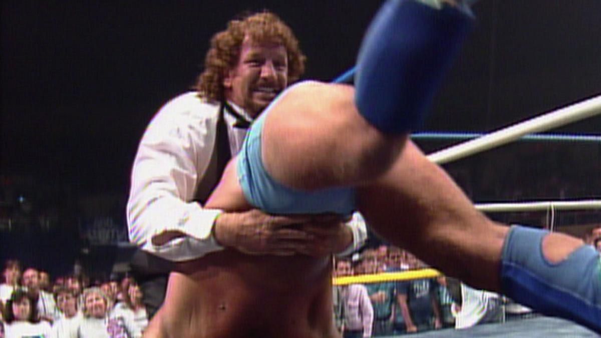 Terry Funk piledrives Ric Flair though a table in WCW