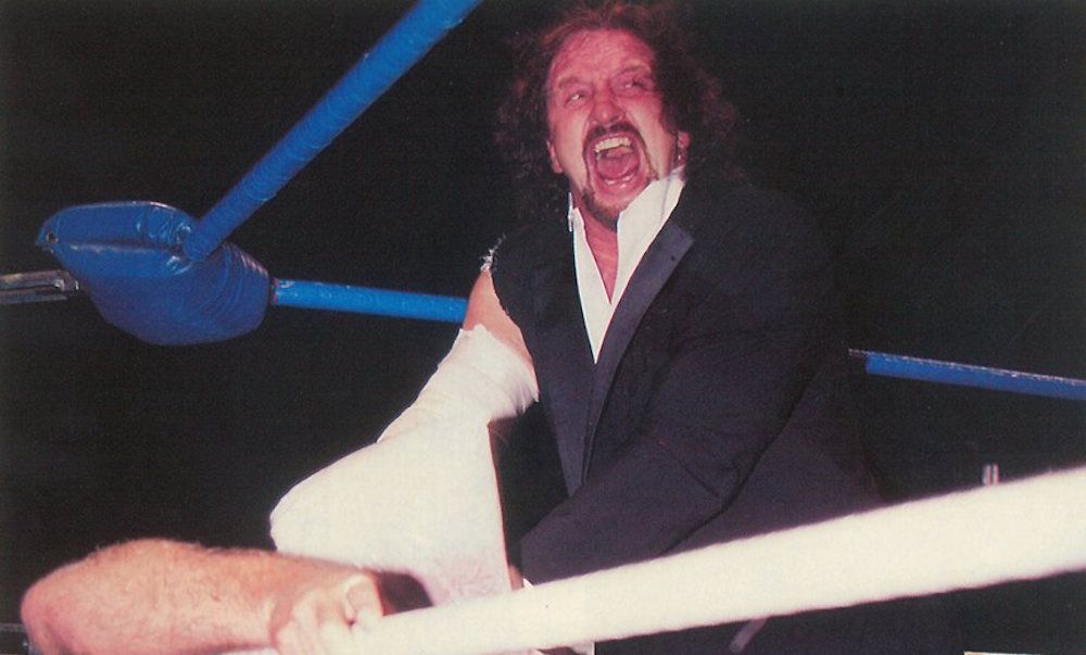 Terry Funk strangles Ric Flair with a plastic bag
