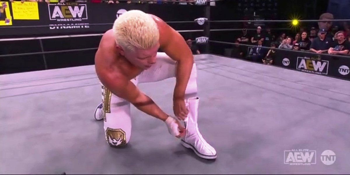 Cody Rhodes taking off his boots