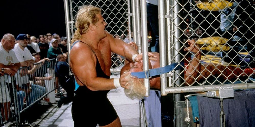 Curt Henning wedging Ric Flair's head in between a steel cage door.