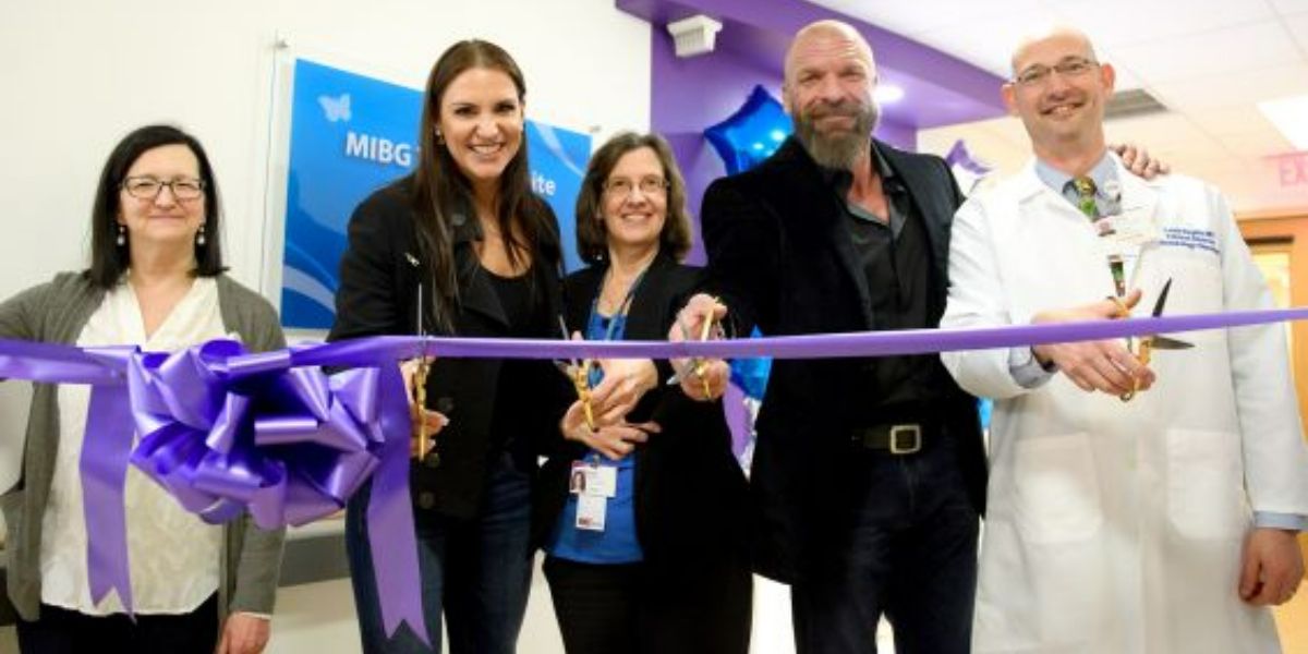 Triple H and Stephanie McMahon in a ribbon cutting ceremony