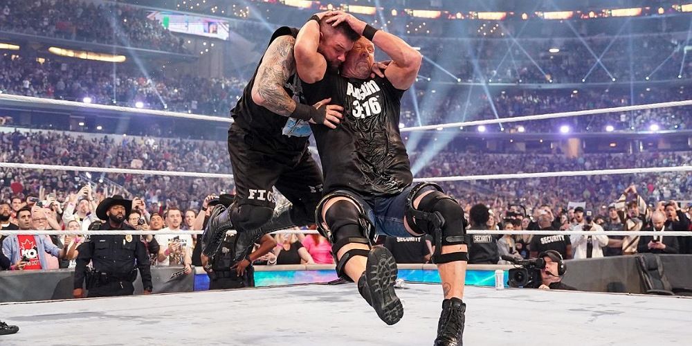 Steve Austin hitting Kevin Owens with a Stunner at WrestleMania 38.