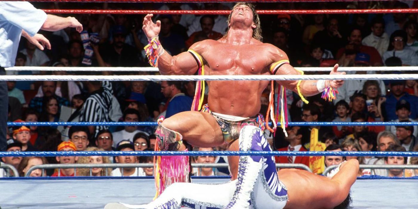 Ultimate Warrior kneeling over Randy Savage
