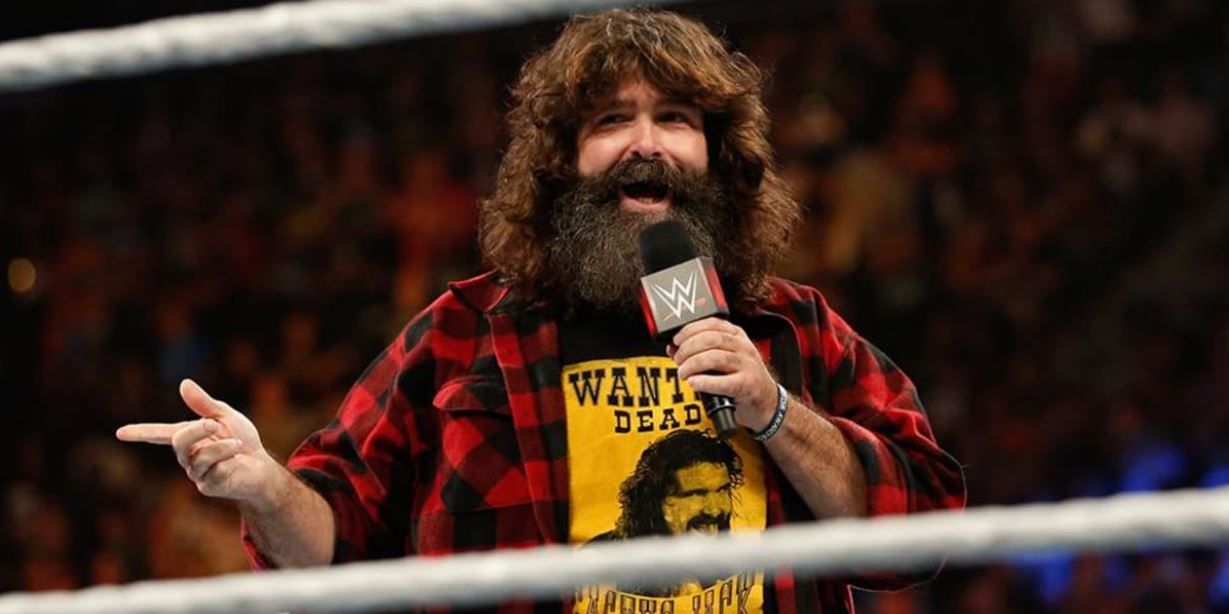 Mick Foley in the ring talking into a microphone