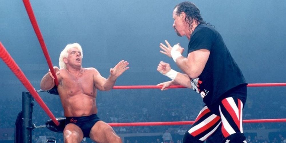 Terry Funk backing Ric Flair down into a corner.