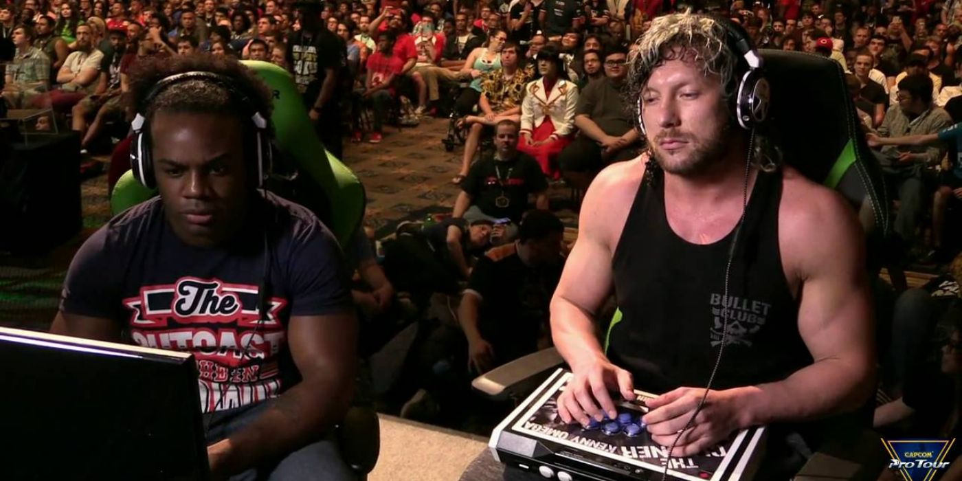 Kenny Omega playing with Xavier Woods