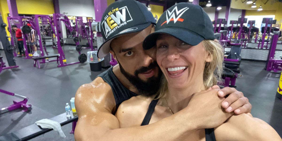 charlotte and andrade wearing wwe and aew hats respectively