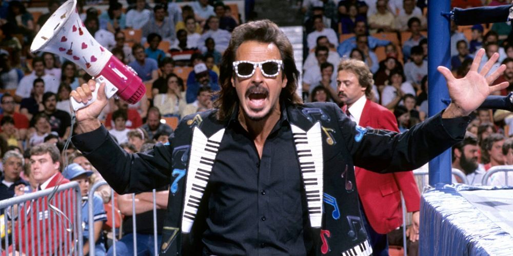 Jimmy Hart with his arms open.