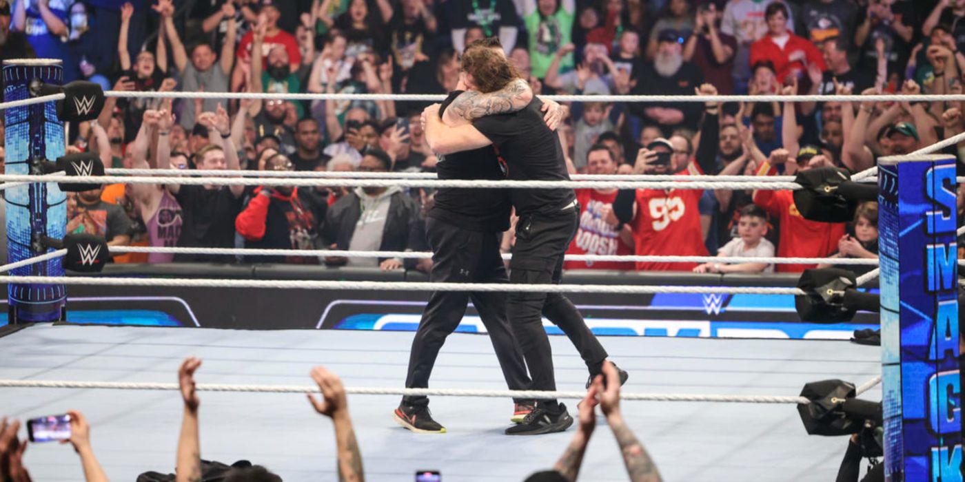 kevin owens and sami zayn hugging in the ring