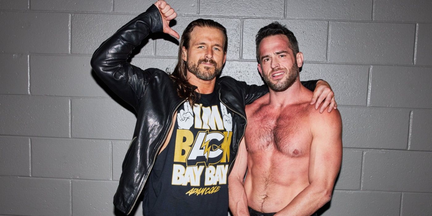 adam cole with his arm around roderick strong