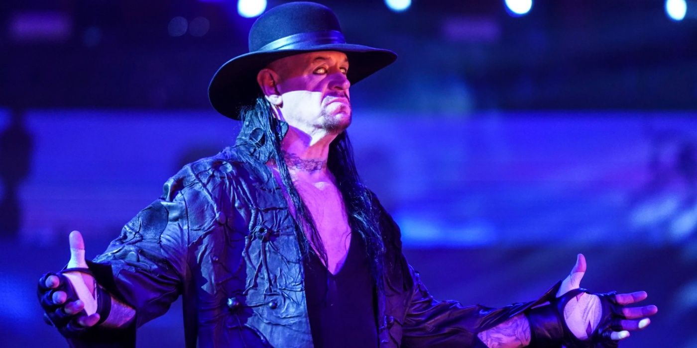 the undertaker posing and rolling his eyes back