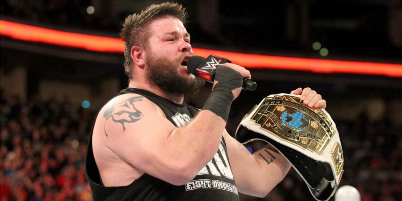 kevin owens holding a mic and the intercontinental title