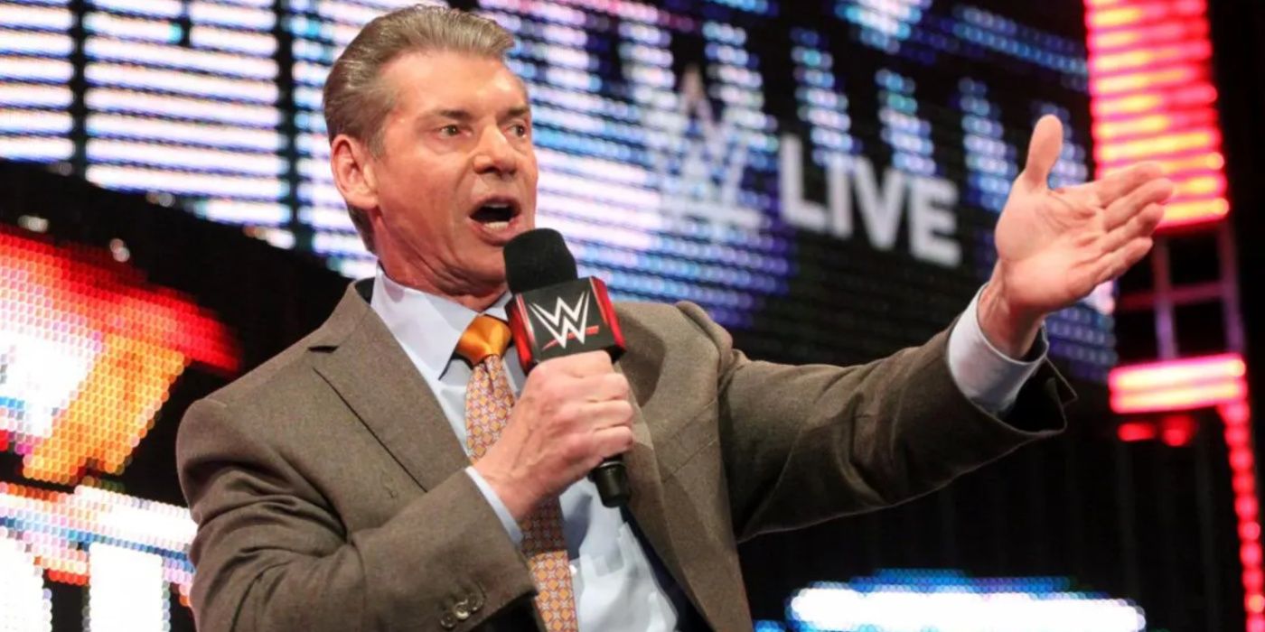 vince mcmahon gesturing and talking into a mic