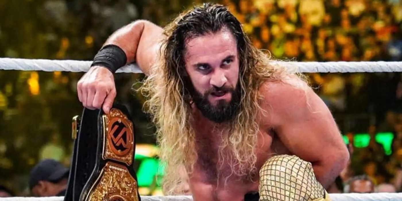 seth rollins leaning on the ropes, holding the world title