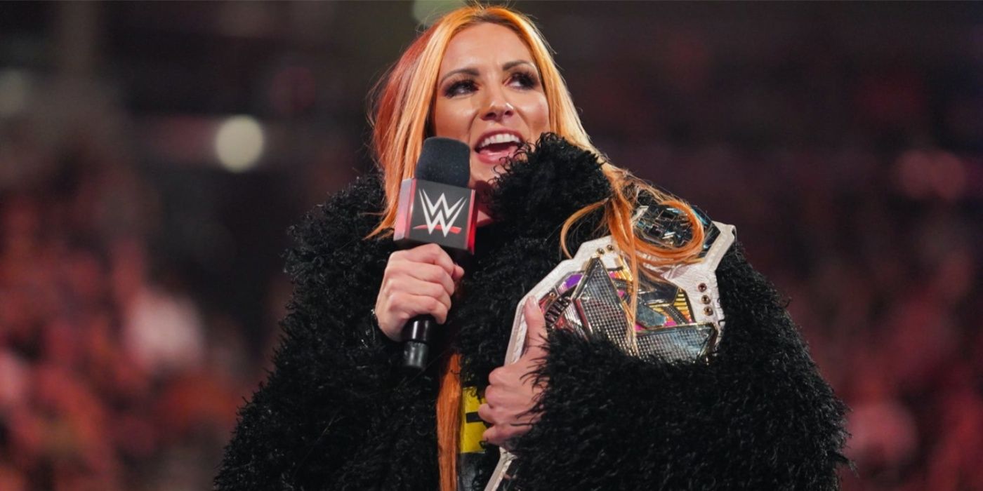 becky lynch speaking into a mic and holding the nxt women's title