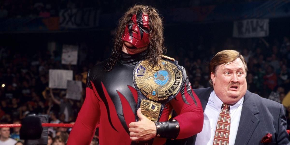 Kane holding the WWE Championship with Paul Bearer by his side