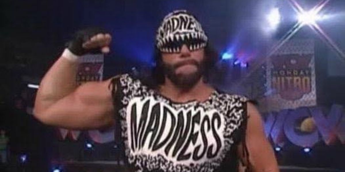 Randy Savage flexing his biceps on his way to a WCW ring