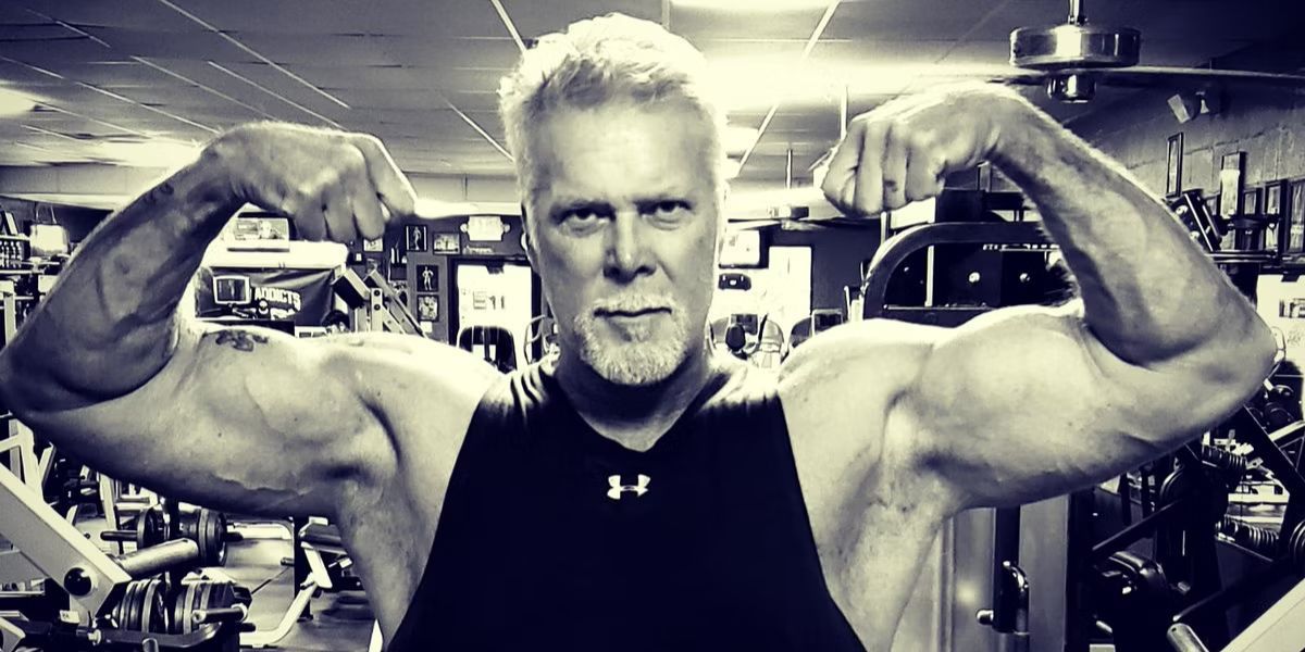 Kevin Nash flexing his muscles in the gym