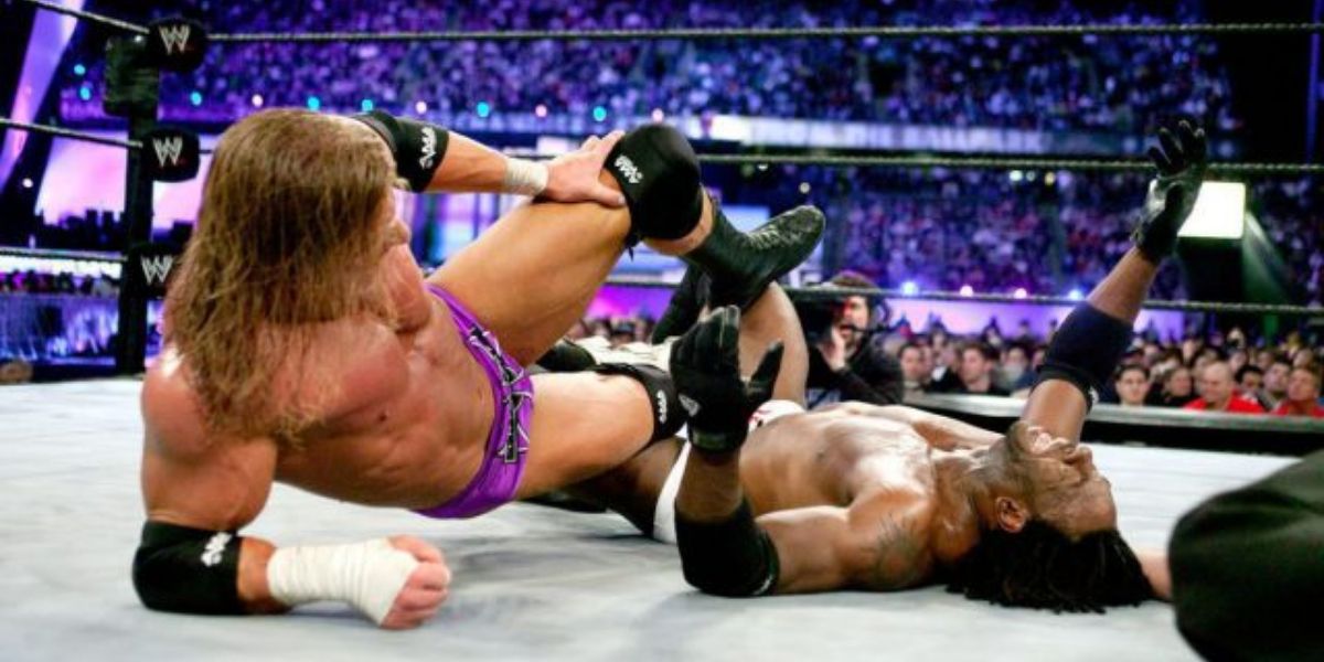 Triple H applies the Indian Deathlock to Booker T at WrestleMania 19