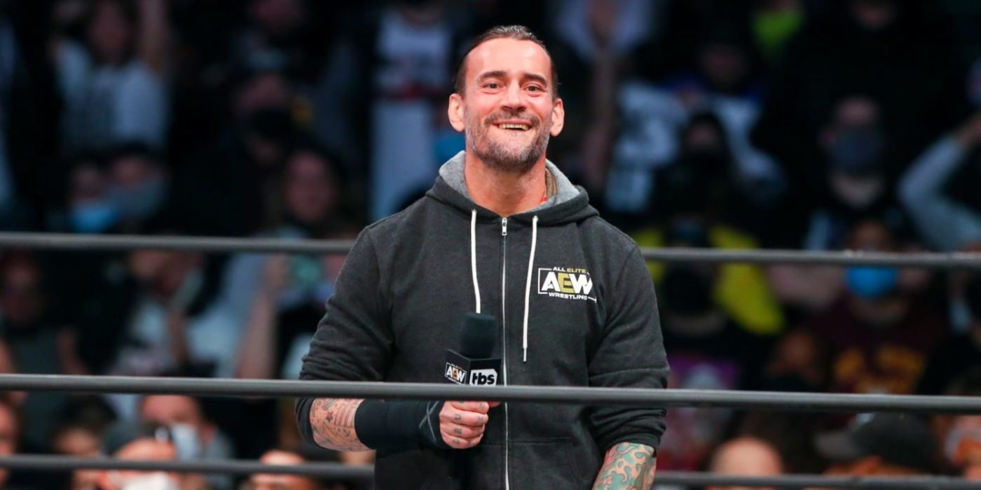 cm punk holding a mic in an aew ring