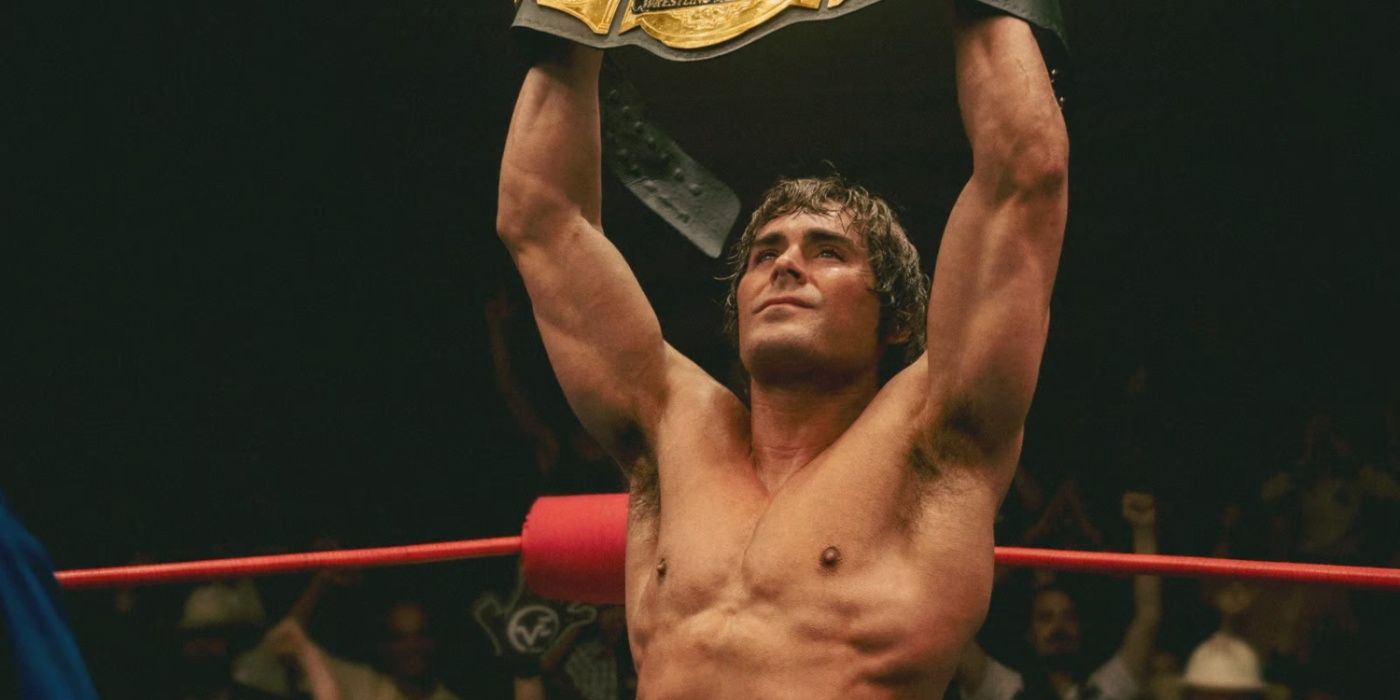 zac efron as kevin von erich holding up a title
