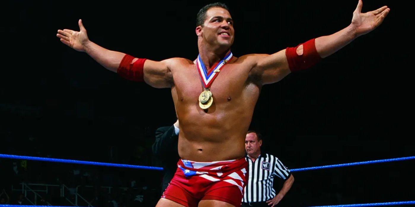 a young kurt angle wearing his gold medals in a wwe ring