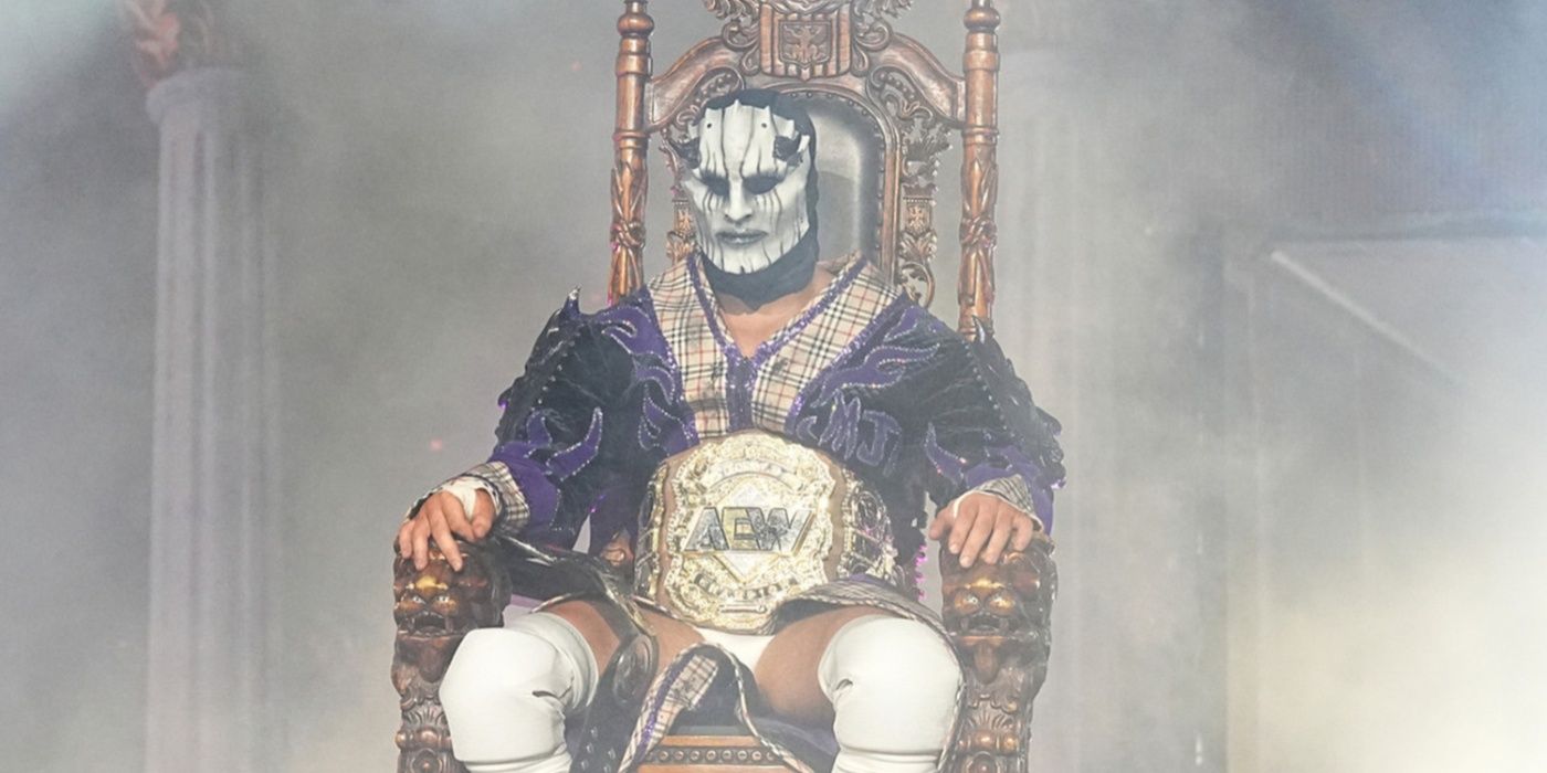 mjf in a devil mask sat on a throne