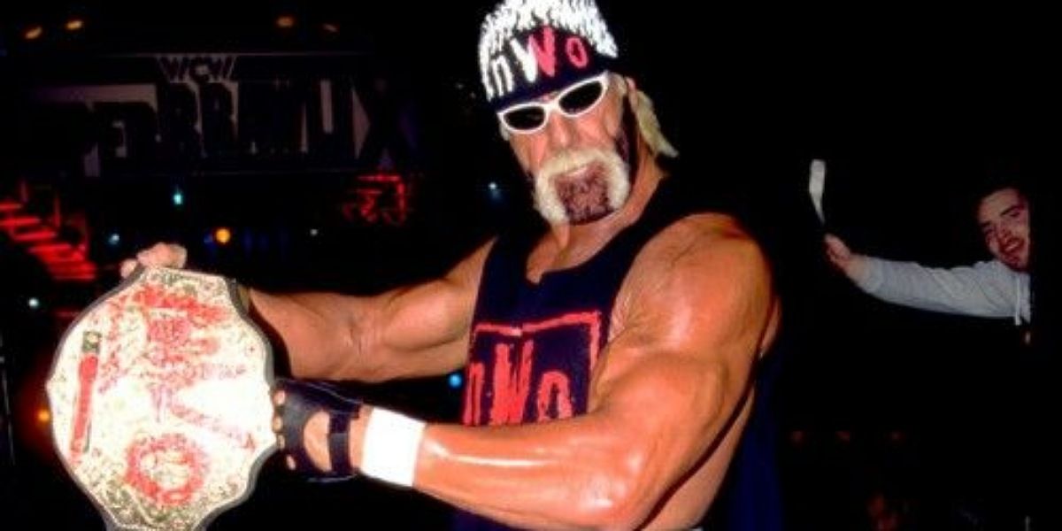 Hollywood Hogan posing with the spray painted nWo Championship. 