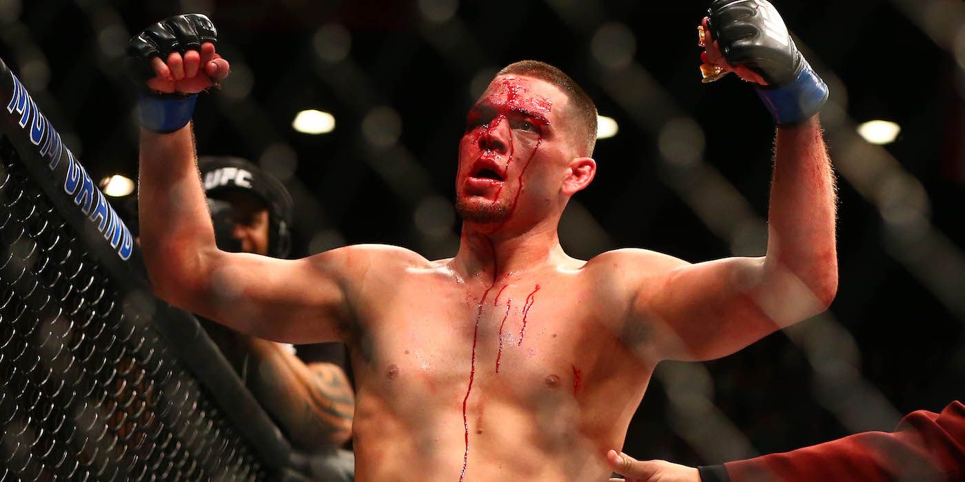 Nate Diaz raises his hands after submitting Conor McGregor at UFC 196