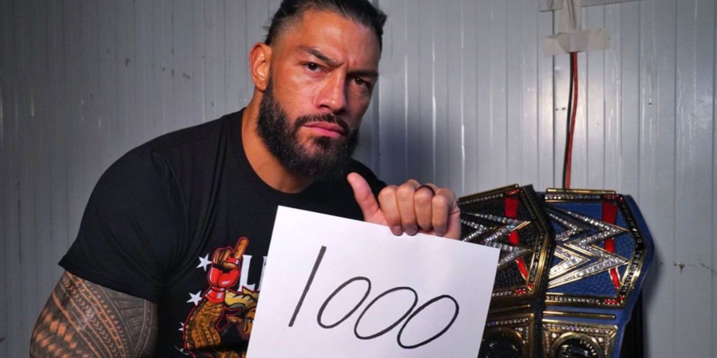 roman reigns holding up a 1,000 sign