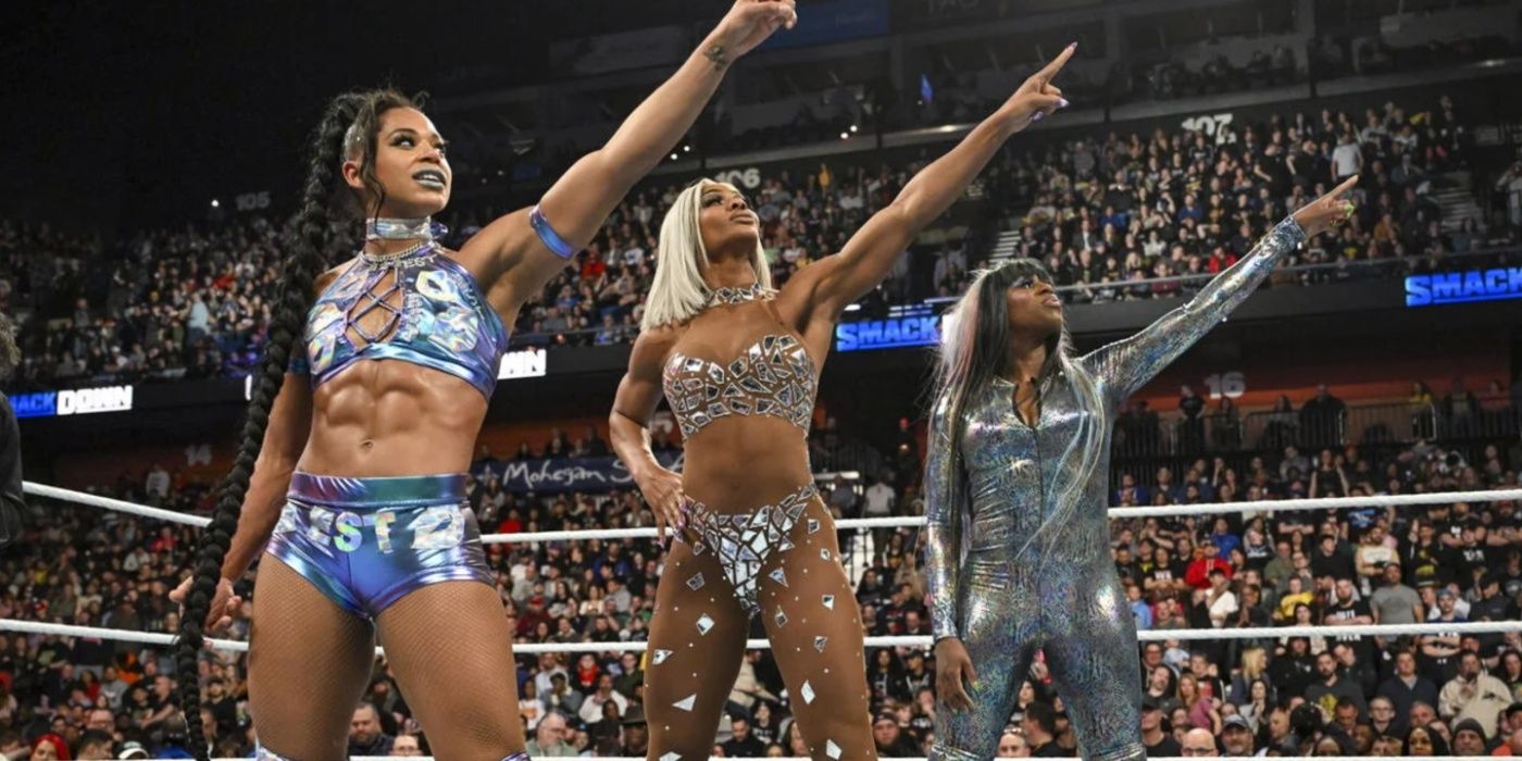 bianca belair jade cargill and naomi pointing at the wrestlemania sign