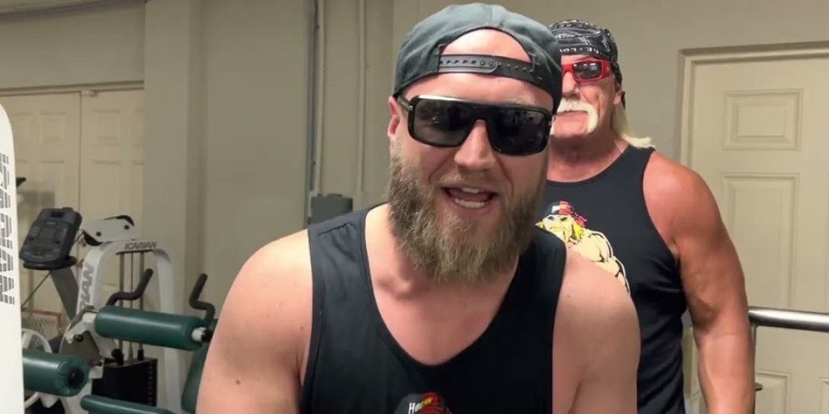 Nick Hogan wearing sunglasses with Hulk Hogan standing behind him