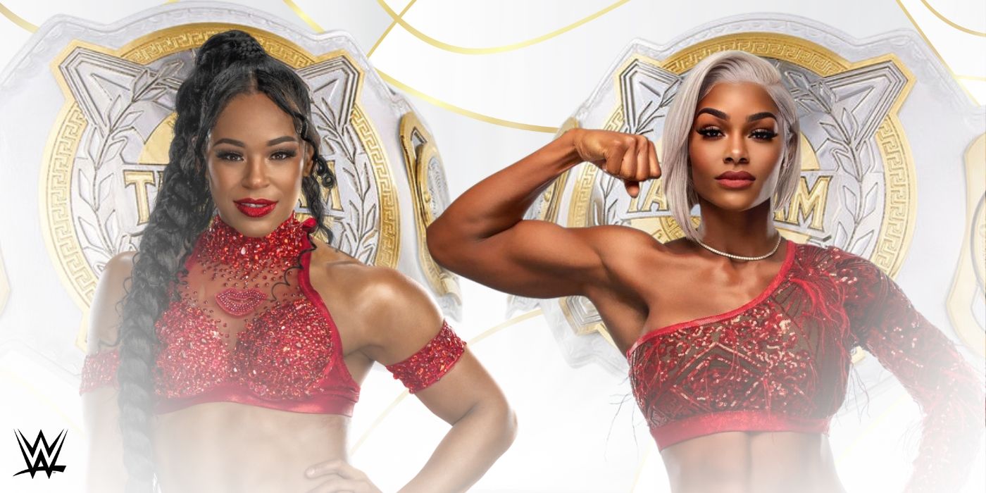 Bianca Belair and Jade Cargill dressed in red in front of the WWE Women's Tag Team Championships