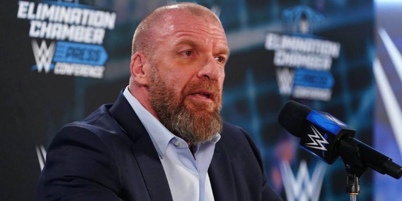 triple h speaking into a mic at a wwe press conference