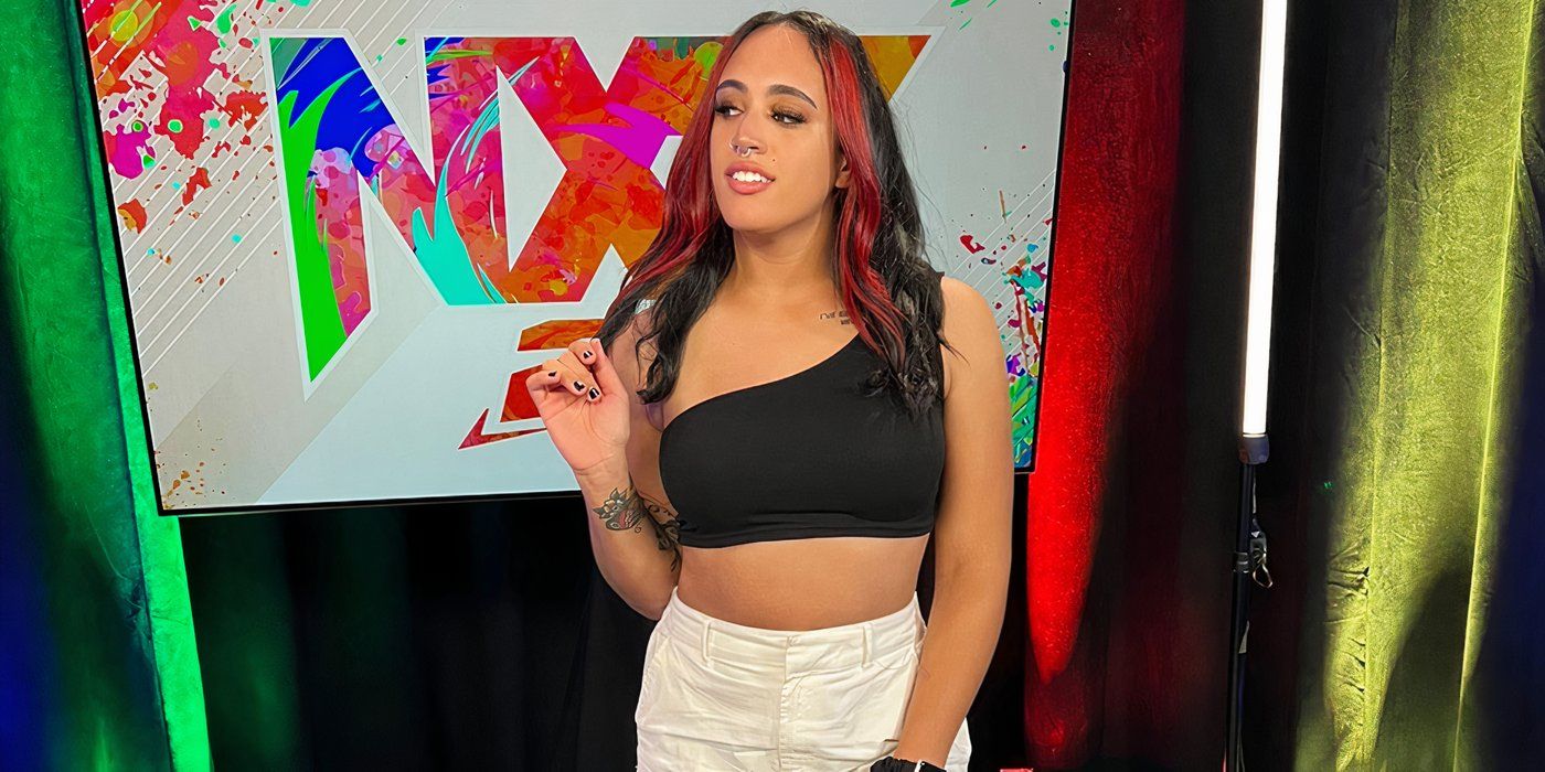 Ava Raine by the NXT sign