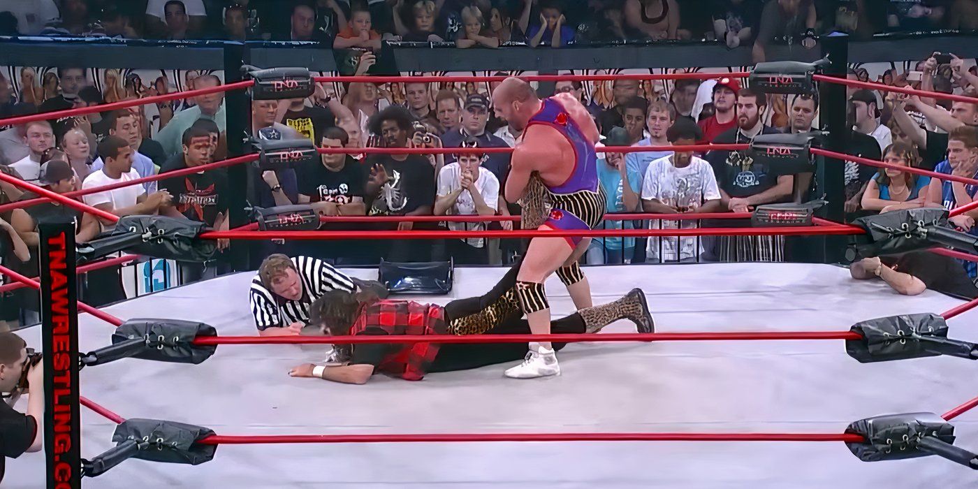 Kurt-Angle-locking-in-the-Ankle-Lock-on-Mick-Foley