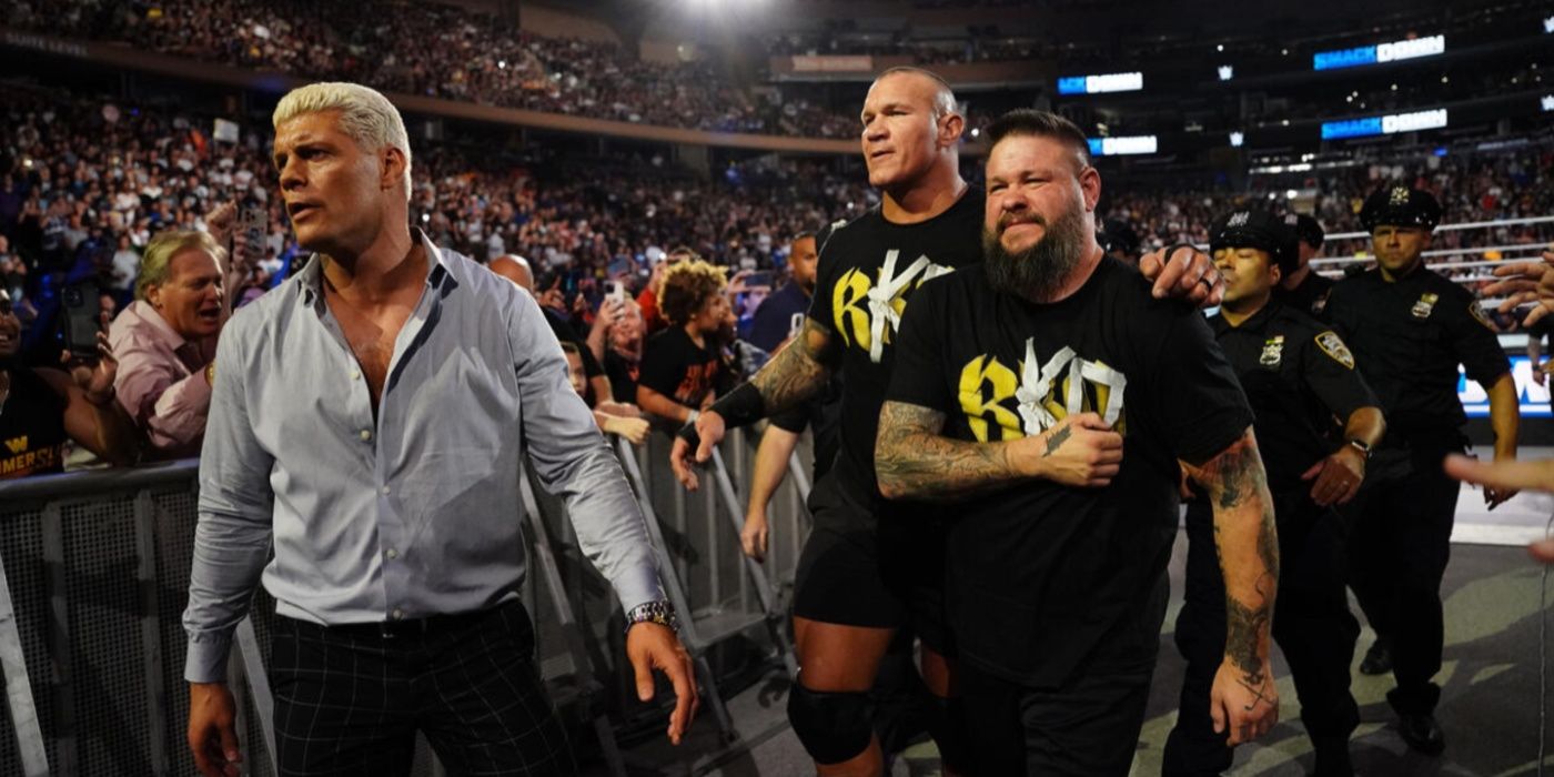 cody rhodes randy orton and kevin owens being escorted from the ring