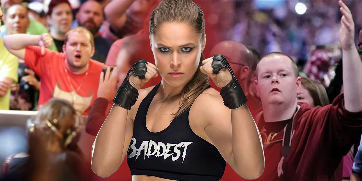 Ronda Rousey with her fists up and fans behind her.