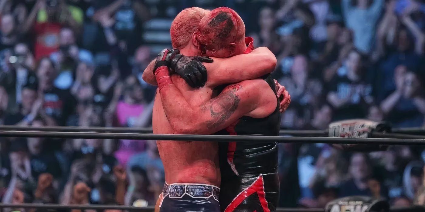 A bloody Cody and Dustin Rhodes hugging