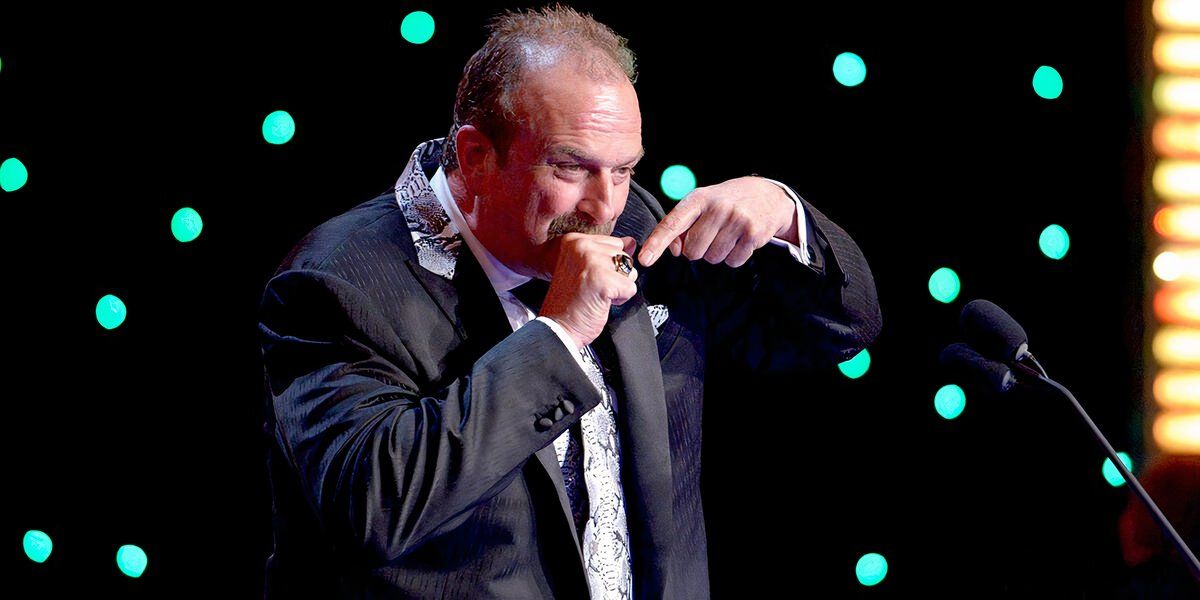 Jake Roberts points at his 2014 WWE Hall of Fame ring