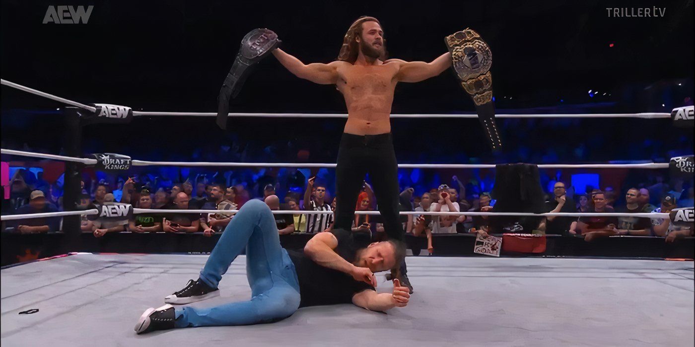 jack perry standing over bryan danielson holding titles