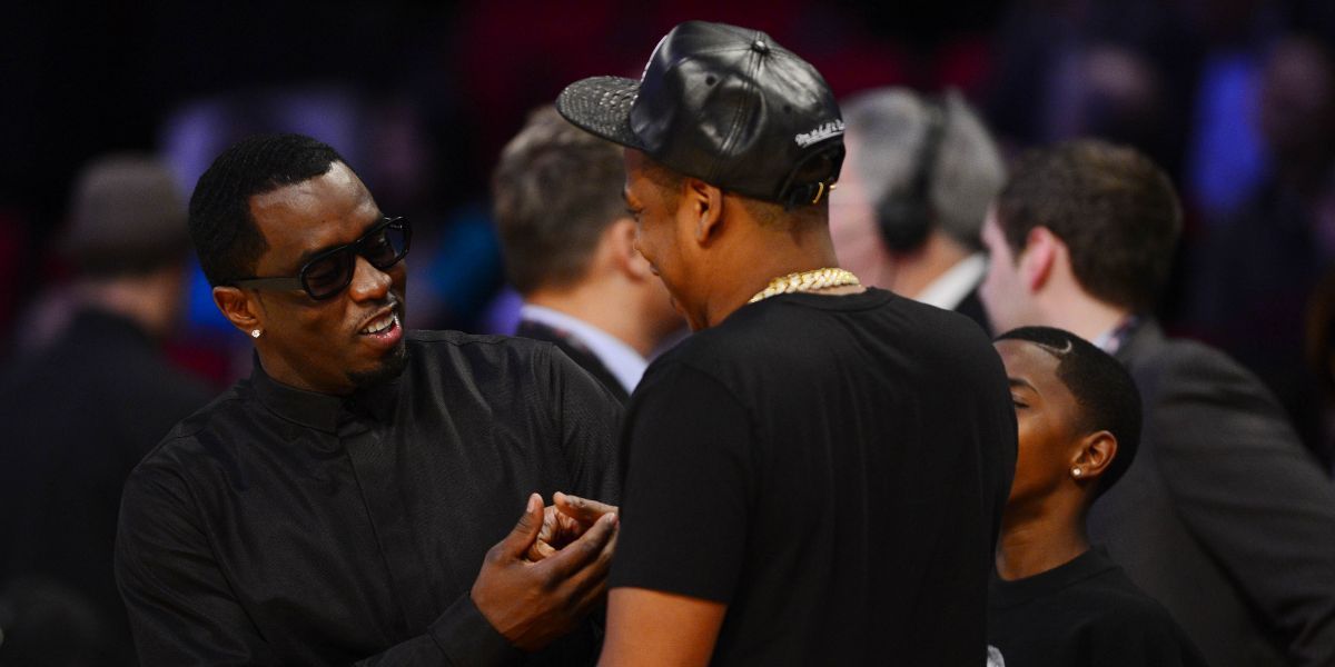 Sean Combs (left) and Jay-Z greet each other before the 2013 NBA all star game at the Toyota Center