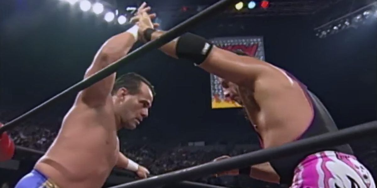 Bret Hart and Dean Malenko tying up in the corner of the ring.