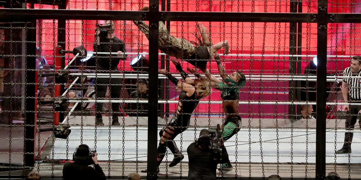 Sarah Logan performs a diving crossbody on Natalya and Ruby Riott at WWE Elimination Chamber 2020